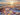Sunset by the sea at sunset, a blanket is lying on the beach, a